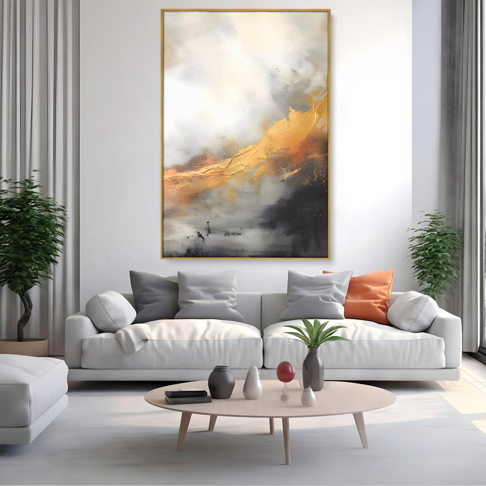 Tablou canvas cu pictura abstracta cu tusa aurie si tonuri gri, in rama de aluminiu auriu, pe perete intr-un living